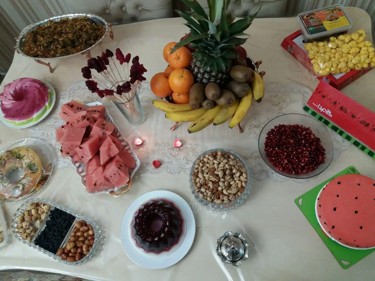 سفره‌ی شب چله در تبریز با هندوانه‌ی برش‌خورده، انار، آناناس، پرتقال و شیرینی